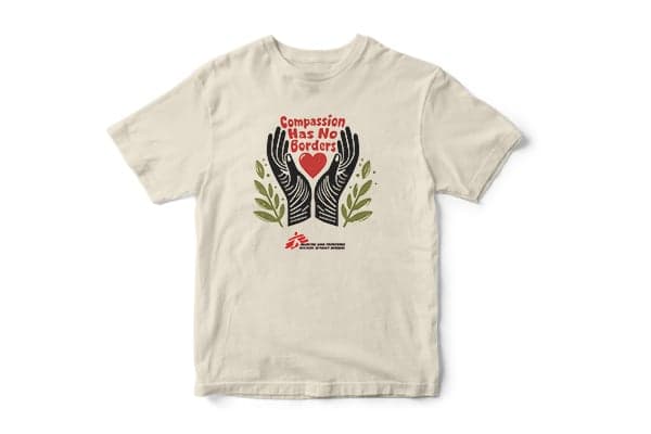 Cream-colored t-shirt with a custom hands and heart design that says "Compassion Has No Borders". Below that is the MSF logo.