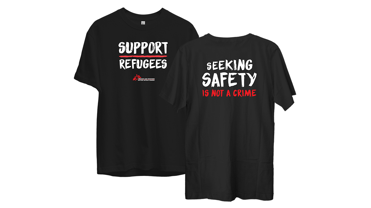 Cream-colored t-shirt with a custom hands and heart design that says "Compassion Has No Borders"