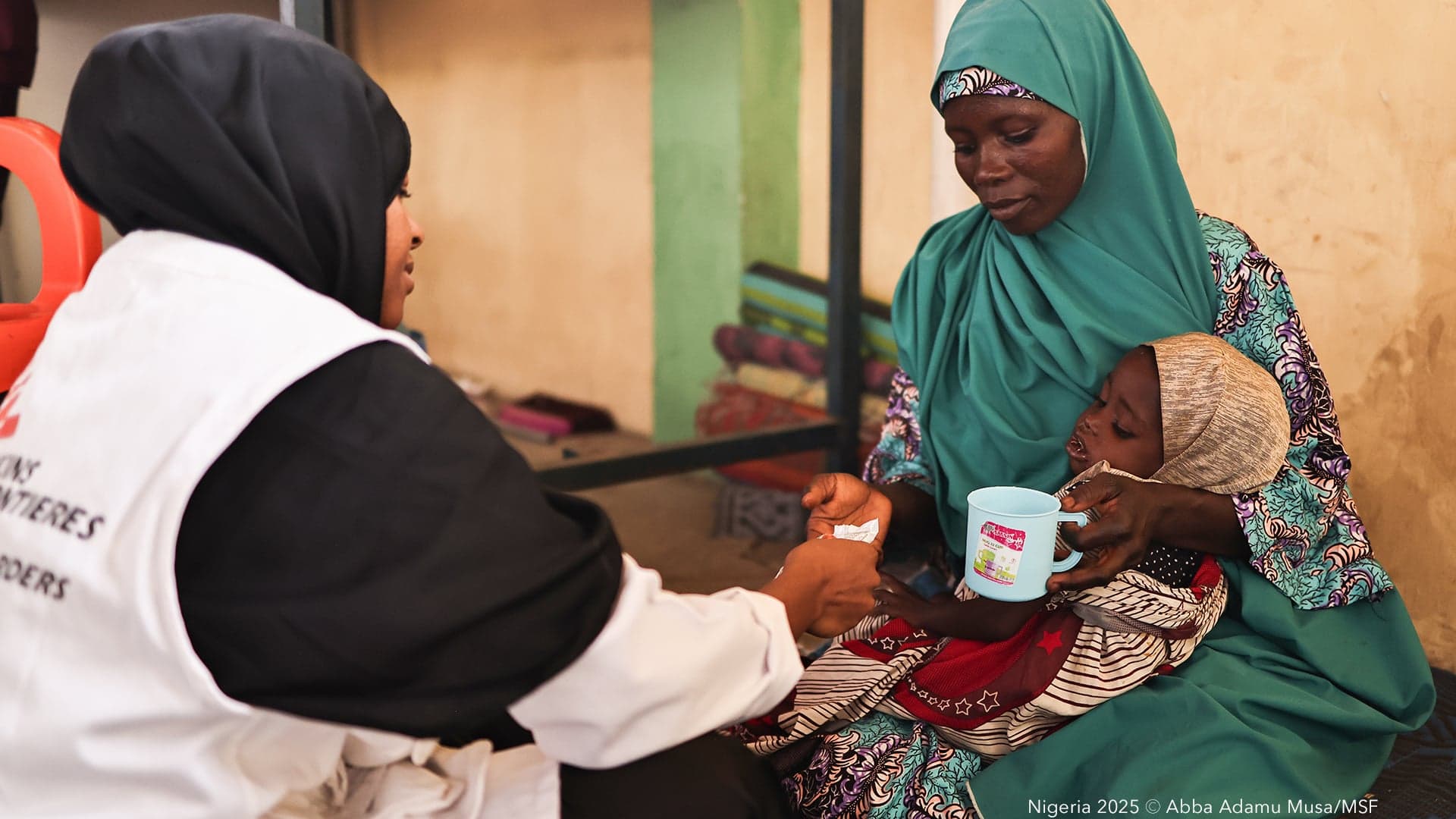Doctors Without Borders / Médecins Sans Frontières staff examine a patient at the Ambulatory Therapeutic Feeding Center in Kano state, Nigeria.